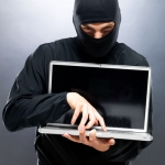 ninja / thief holding laptop