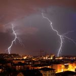 lightning striking over city