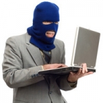 thief holding laptop