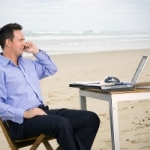 person's desk set up on beach