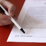 sign here on piece of paper